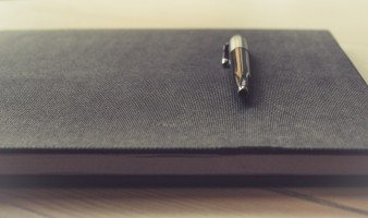 ball-pen-on-top-of-elegant-notebook